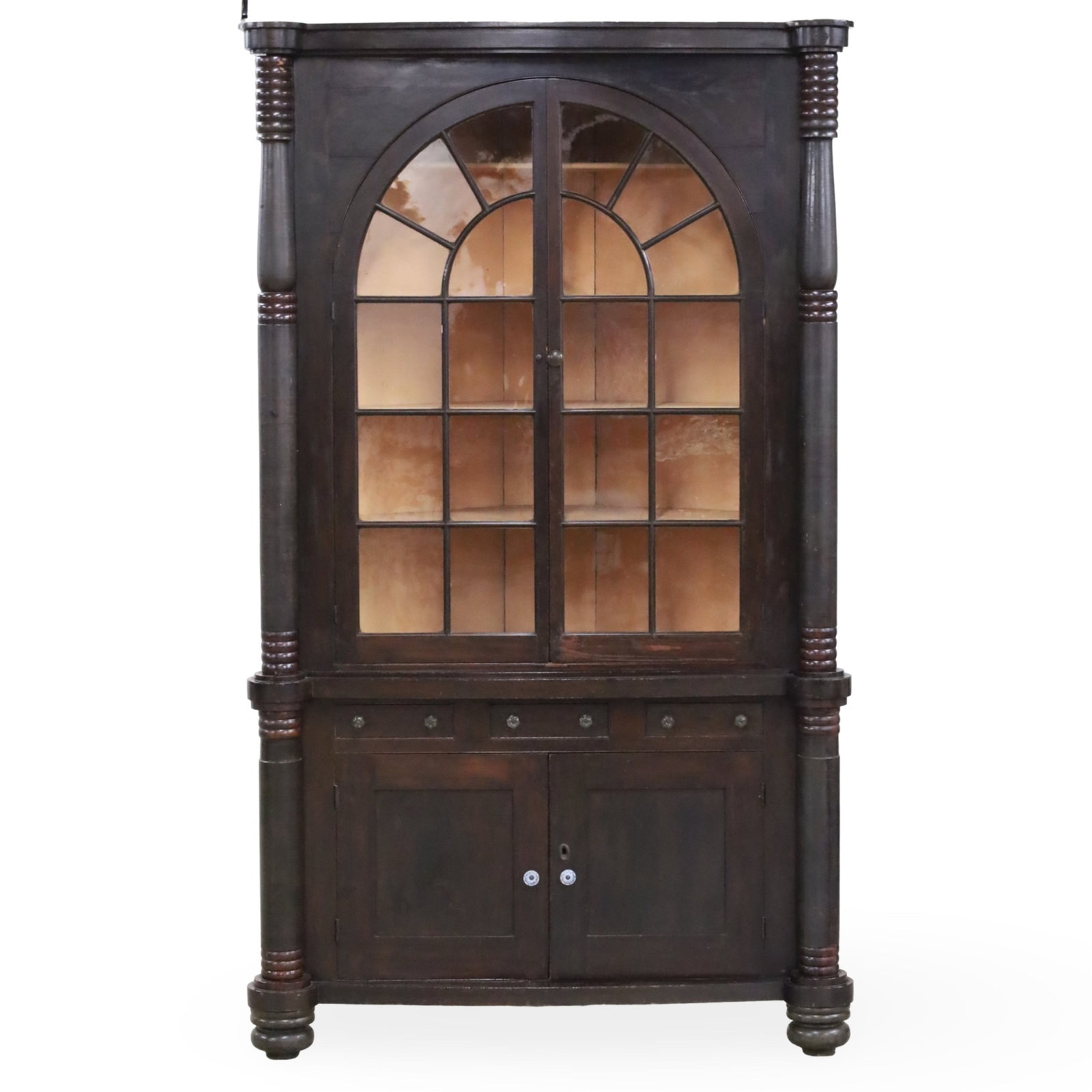 AMERICAN FEDERAL CORNER CABINET: Antique walnut corner cabinet, likely from the American Federal period, featuring origianl arched glass-paned doors and turned columns, early 19th century;