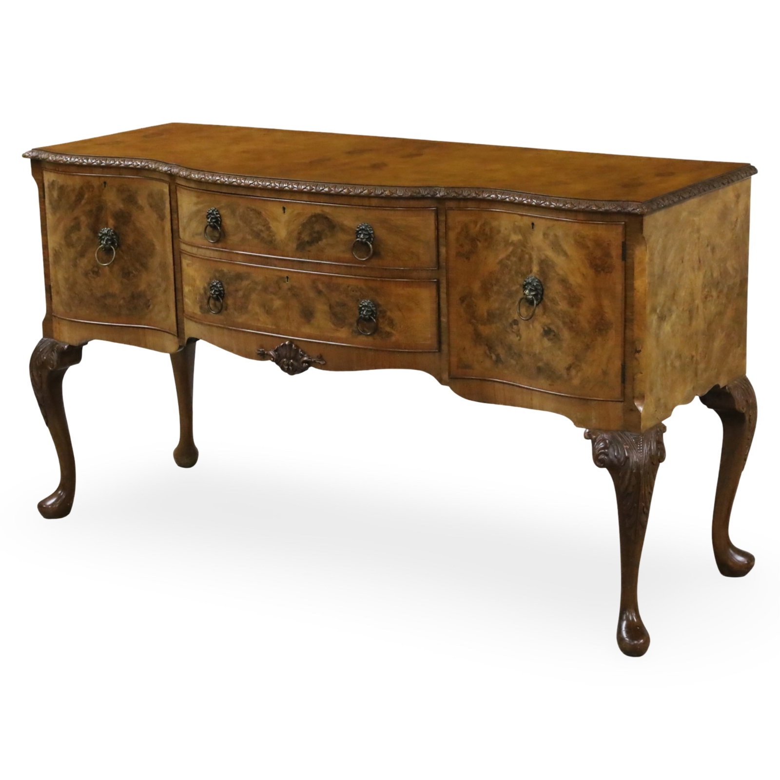 QUEEN ANNE STYLE WALNUT SIDEBOARD: Queen Anne style walnut sideboard, the top with repeating foliate molding, lion mask handles, and raised on scrolled cabriole legs on pad feet, early to mid 20th century; 37"H 65"W 24"D