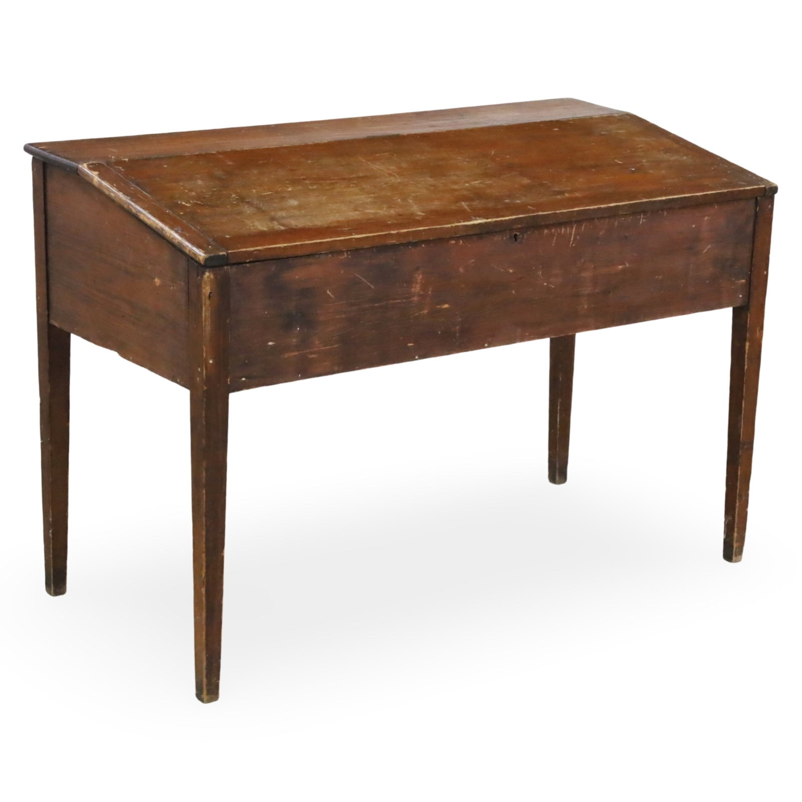 AMERICAN PINE SCHOOLMASTER DESK, 19TH C.: American pine schoolmaster desk having lift top cabinet raised on tapered legs, 19th century; 34.5"H 51"W 25"D