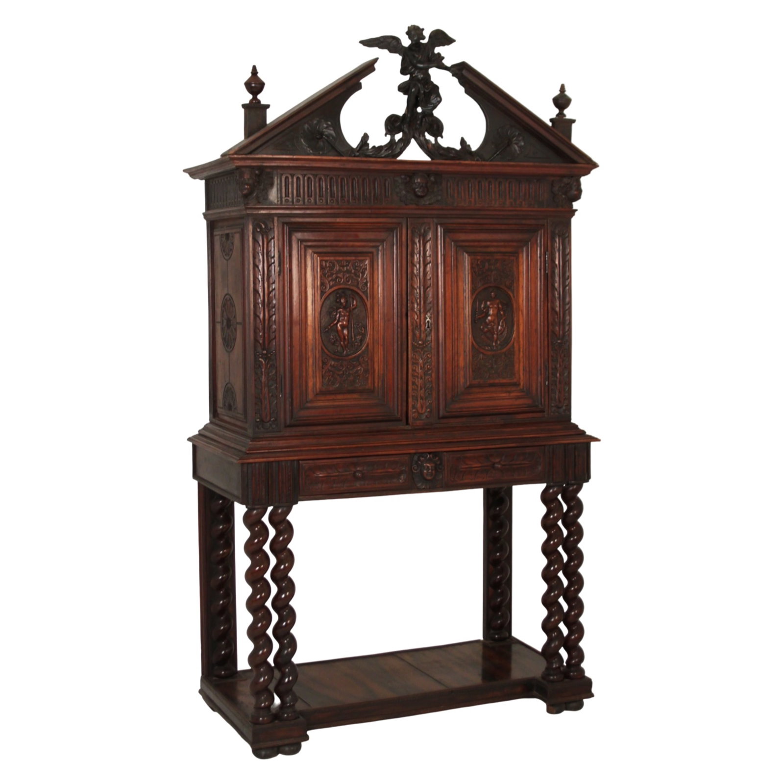 ITALIAN CARVED WALNUT CABINET, 18TH C.: Finely carved Italian walnut cabinet on stand having broken arch pediment mounted with center cherub, heavily carved two door cabinet case with cherub masks and foliate decoration, raised on barley tw