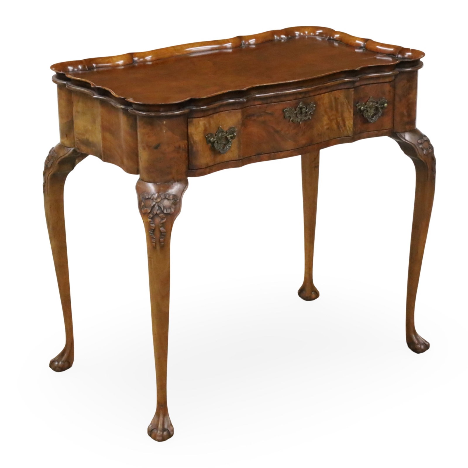 CHIPPENDALE STYLE BURR WALNUT DRESSING TABLE: Chippendale style burr walnut dressing table, having set scalloped tray top above a single drawer, raised on cabriole legs with ribbon carved knees, resting on ball and claw feet, early 20th century; 