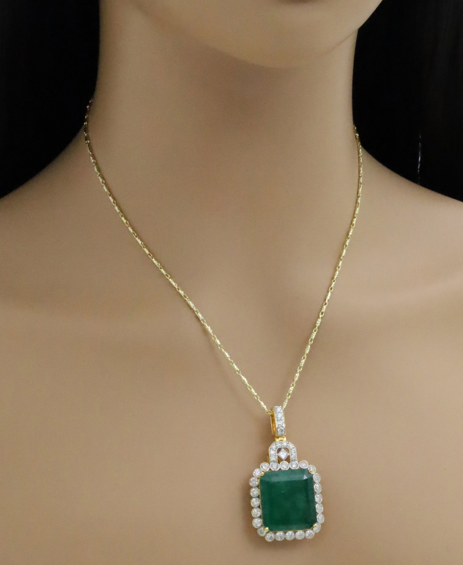 14K GOLD EMERALD AND DIAMOND PENDANT: 14k yellow gold necklace with 26.3ct emerald and 2.38cts of diamonds. chain is 18inches in length. weight of 18.2grams. Please see all photos and appraisal. Note: this lot must be paid with bank wire 