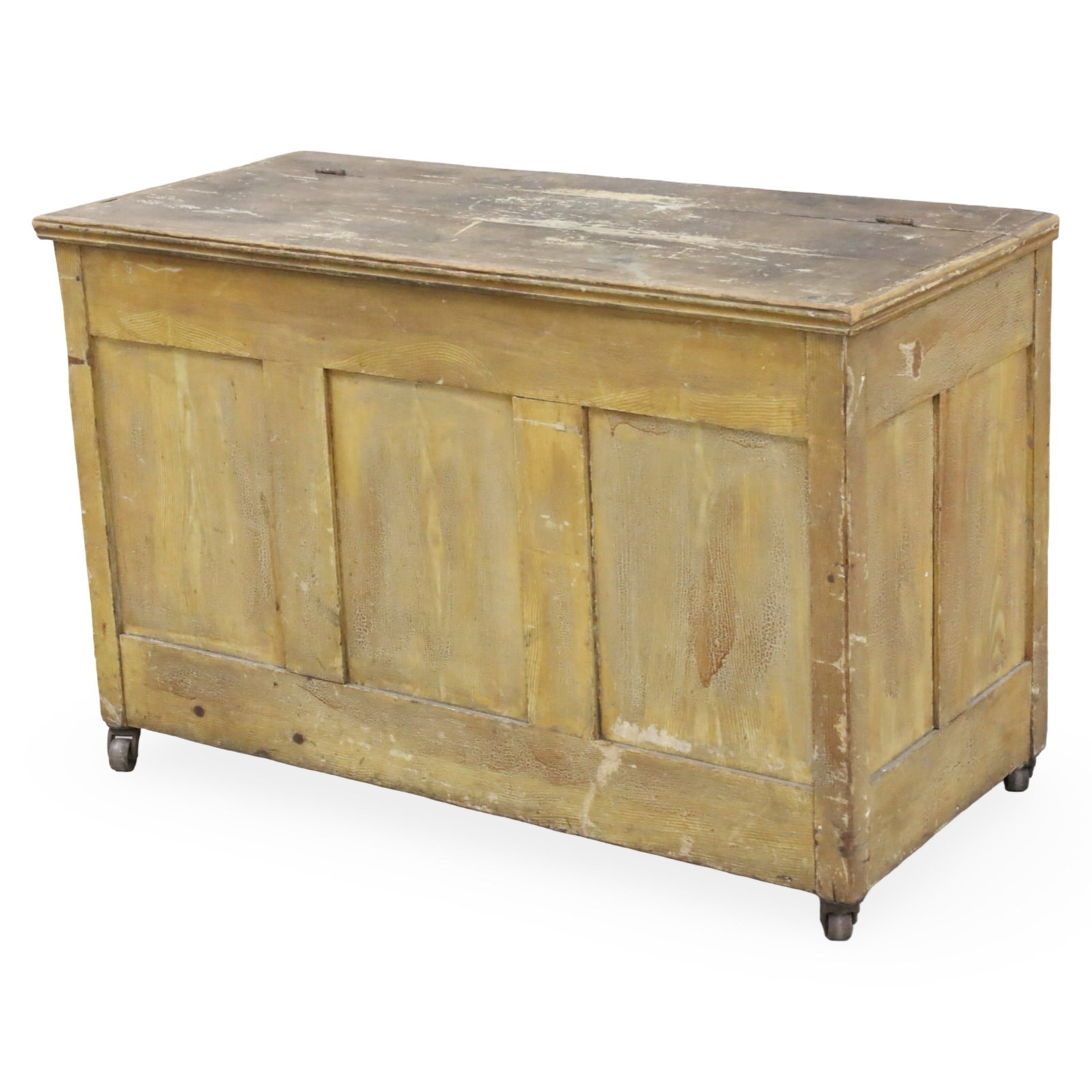 AMERICAN PRIMITIVE PINE LIFT TOP CHEST, 19TH C.: American primitive pine lift top chest, paneled case resting metal casters, late 19th century; 32"H 50"W 22"D