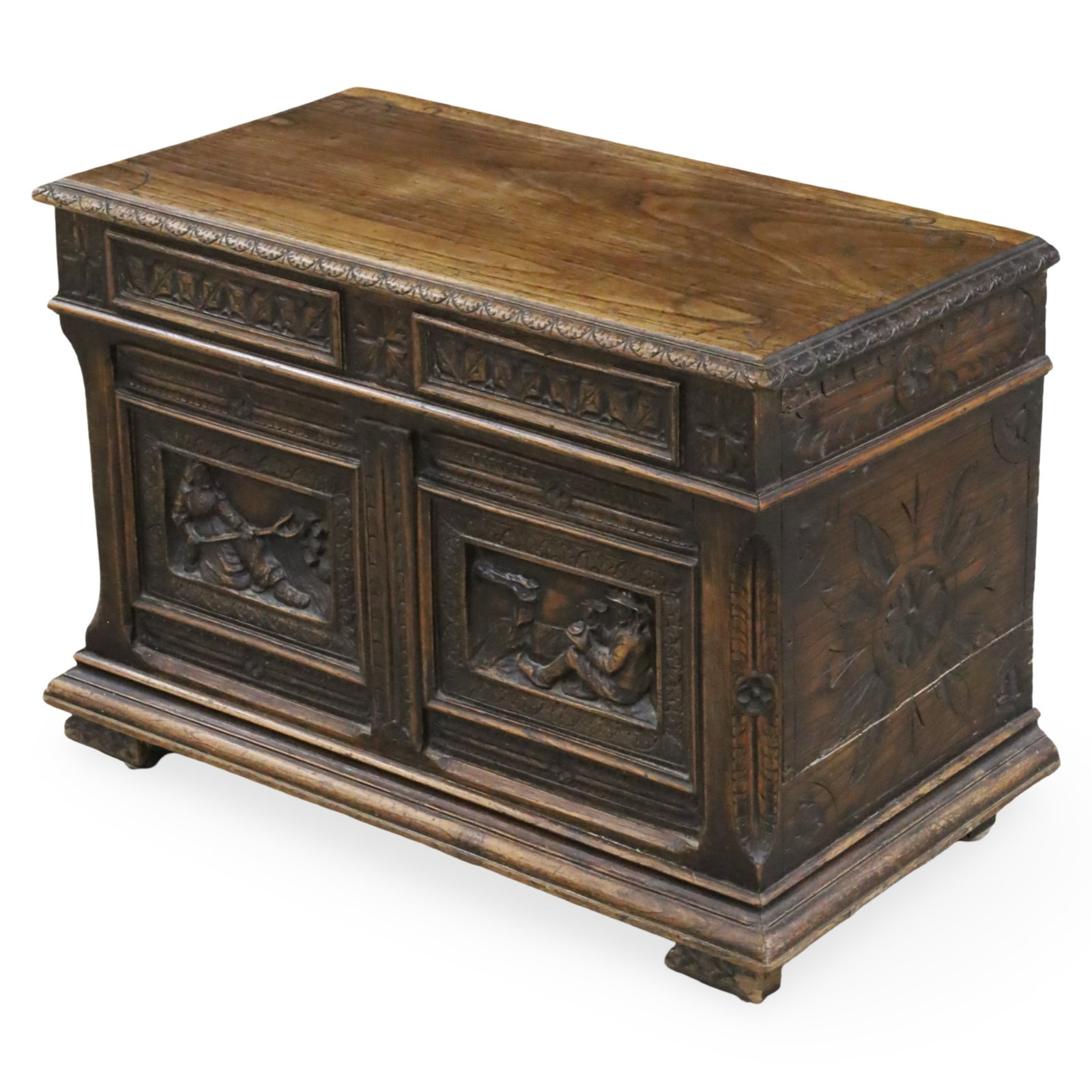 PROVINCIAL FRENCH OAK PETITE COFER, 19TH C.: Provincial French oak cofer, a petite size having a lift top, the case heavily carved with rosette and figural reserves, 19th century; 20.5"H 29"W 15"D