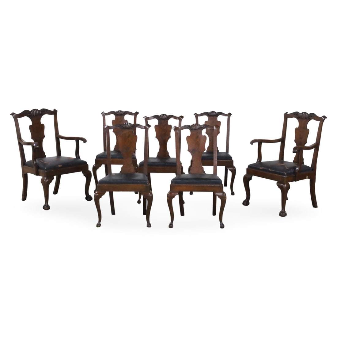 SEVEN AMERICAN MAHOGANY DINING CHAIRS: Group of seven American mahogany dining chairs, including five side chairs and pair of armchairs, all having shell carved crest rails, shaped center splats, and raised on cabriole legs with ball claw 