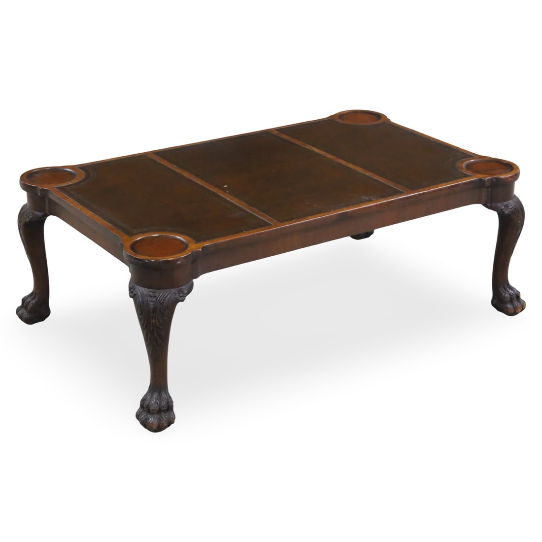 IRISH CHIPPENDALE STYLE LOW TABLE: Irish Chippendale style low or coffee table having triple panel leather top, carved coaster moldings at shoulders, raised on cabriole legs with hairy paw foot, early 20th century; 15.5"H 42"W 26"D