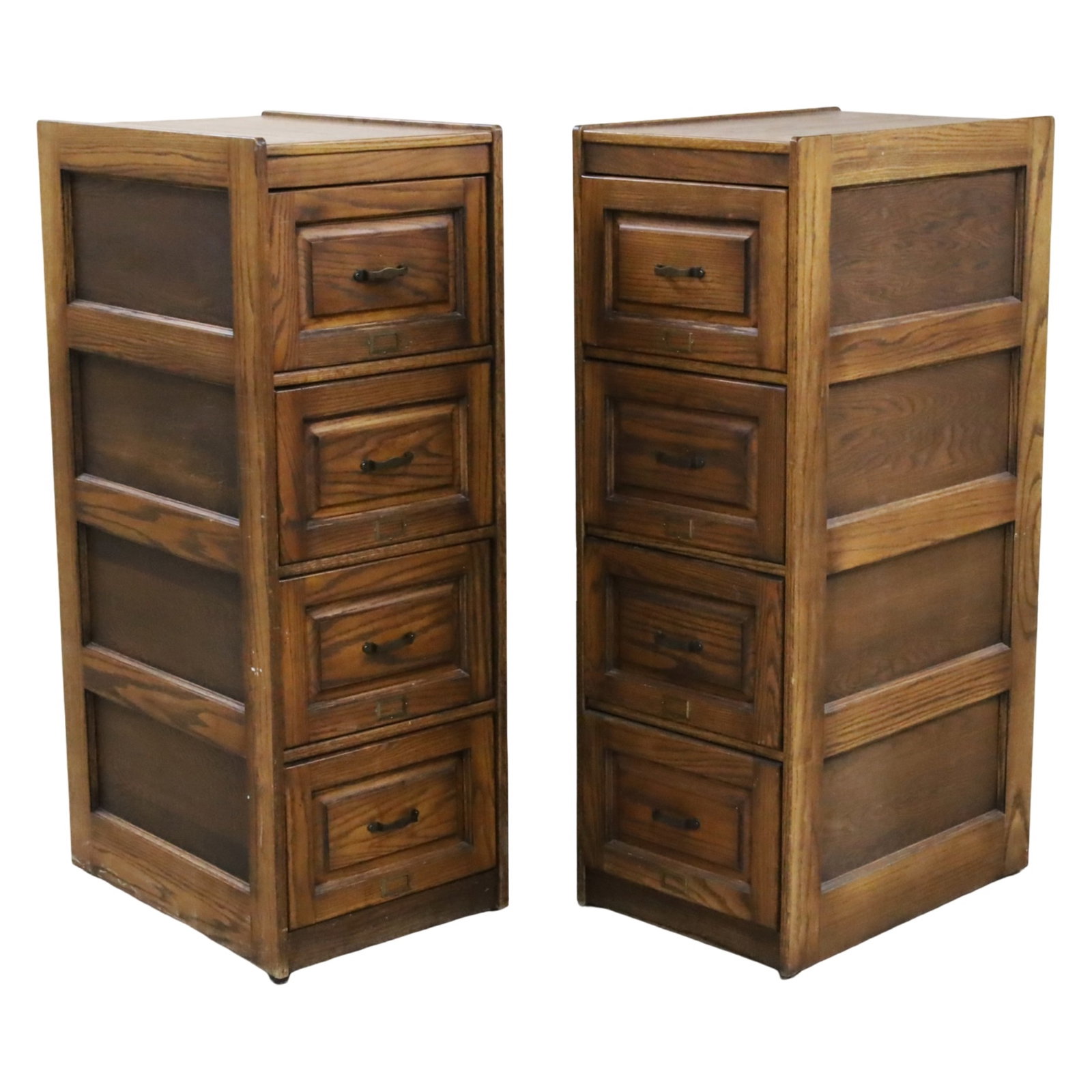 PR SOLID OAK FILE CABINETS: Pair of solid oak four part filing cabinets with paneled doors, mid 20th century; each 54"H 19"W 27"D