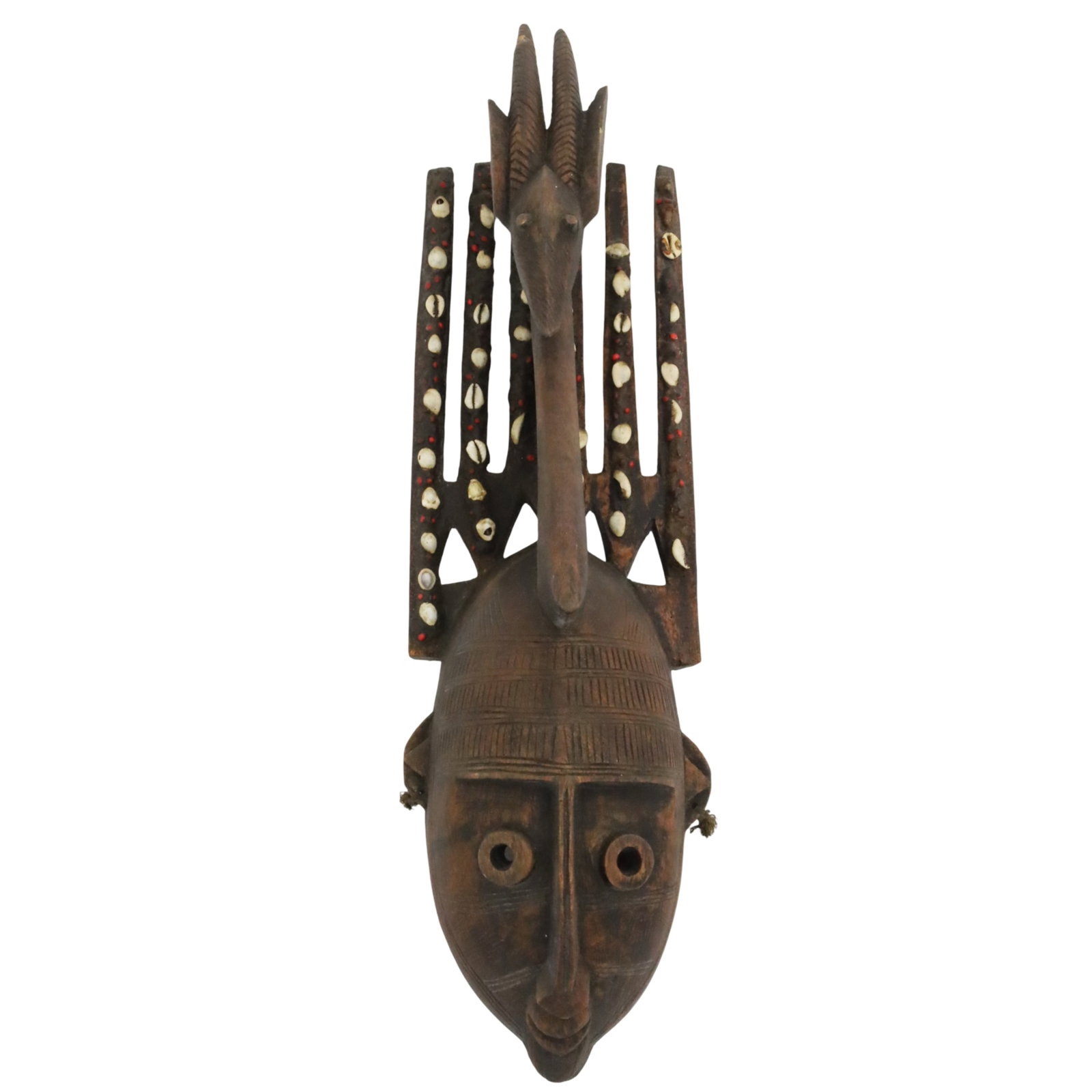AFRICAN BAMANA NTOMO TRIBAL MASK: African Bamana Ntomo tribal mask of the Bambara people, Mali, featuring an antelope surmount and cowrie shell adornments, early to mid-20th century; 28"H 7.5"W 7"D; Provenance: Estate of Clara Juanita
