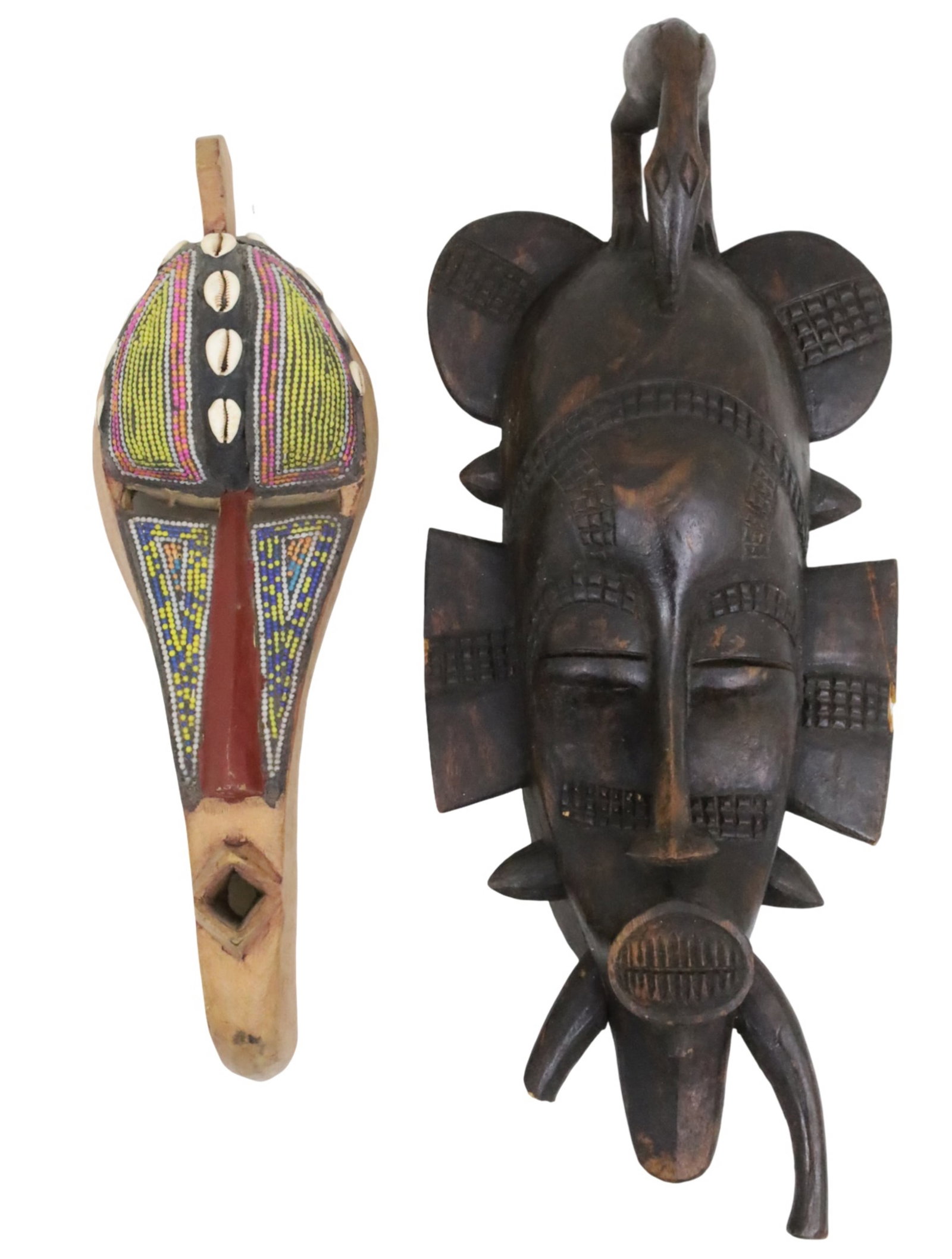 TWO AFRICAN CARVED WOOD CEREMONY MASKS: Two African carved wood cermony masks, including a Senufo Kpelie mask along with a Ghanese mask with bead and shell decoration, 20th century; 23"H 9"W 6"D and 18"H 5.5"W 4.5"D; Provenance: Estate of C