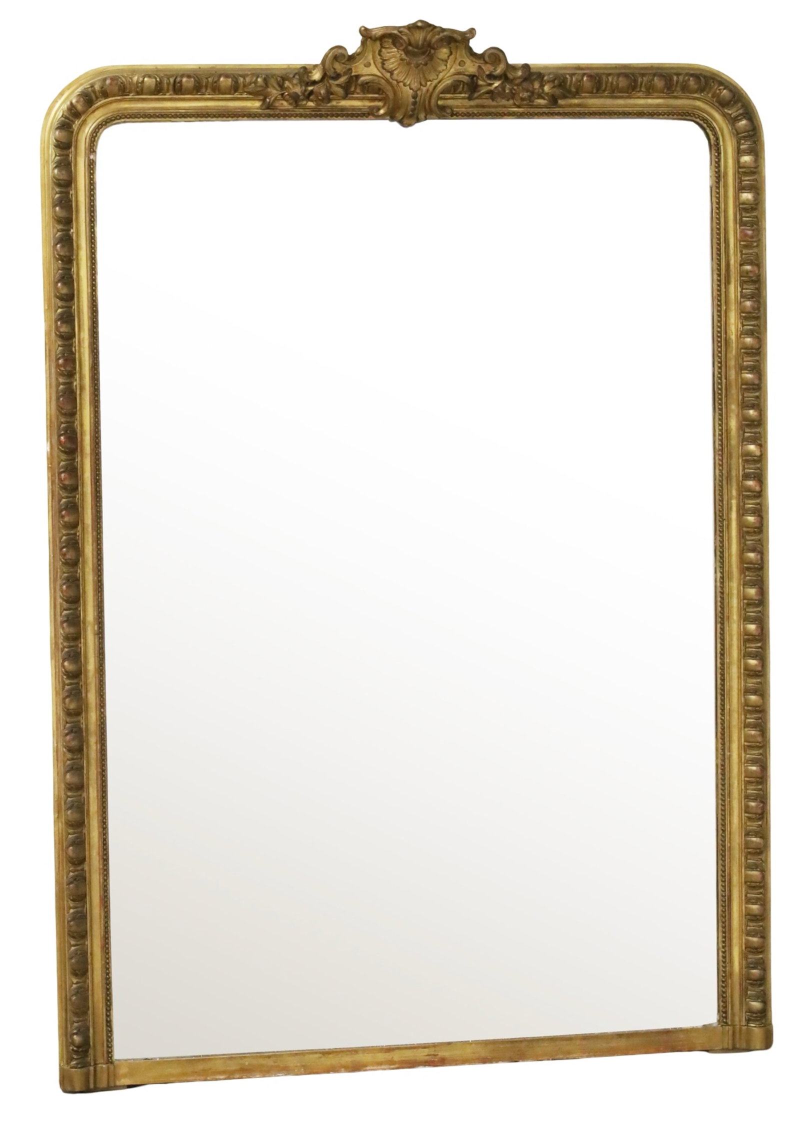 GRAND LOUIS PHILIPPE GILTWOOD MIRROR: Large Louis Philippe giltwood mirror decorated with shell and floral cartouche crest rail, the frame with egg and dart molded border; 70"H 50"W; Condition: small area of silvering loss to mirror at