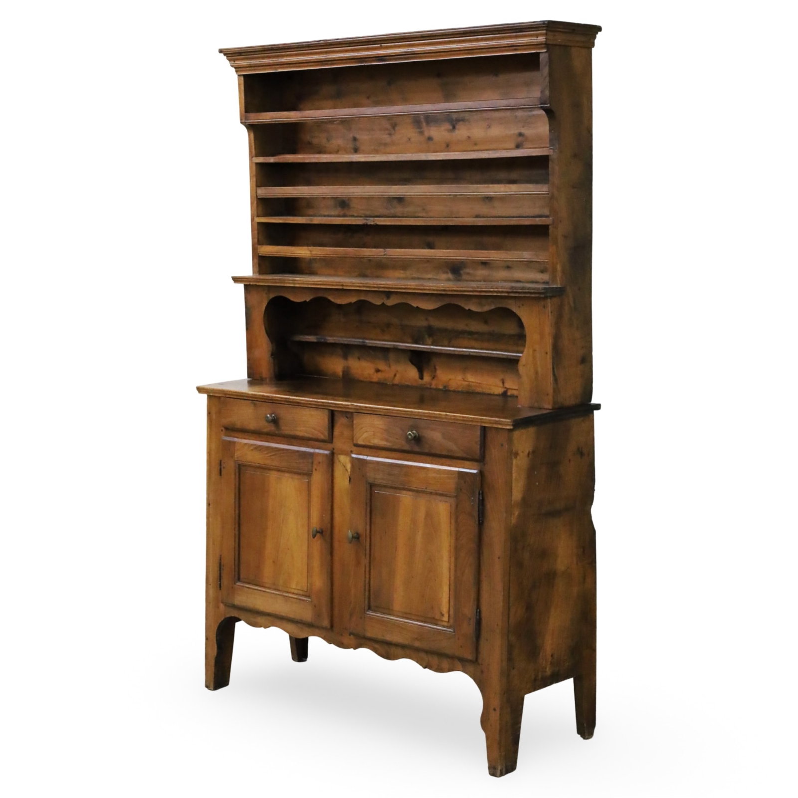 PROVENCAL FRENCH FRUITWOOD VASSELIER, 19TH C.: Provencal French fruitwood vasselier, the case with upper step back plate racks, the lower having slanted side panels, supporting two drawers and double panel door cabinet, having shaped apron and