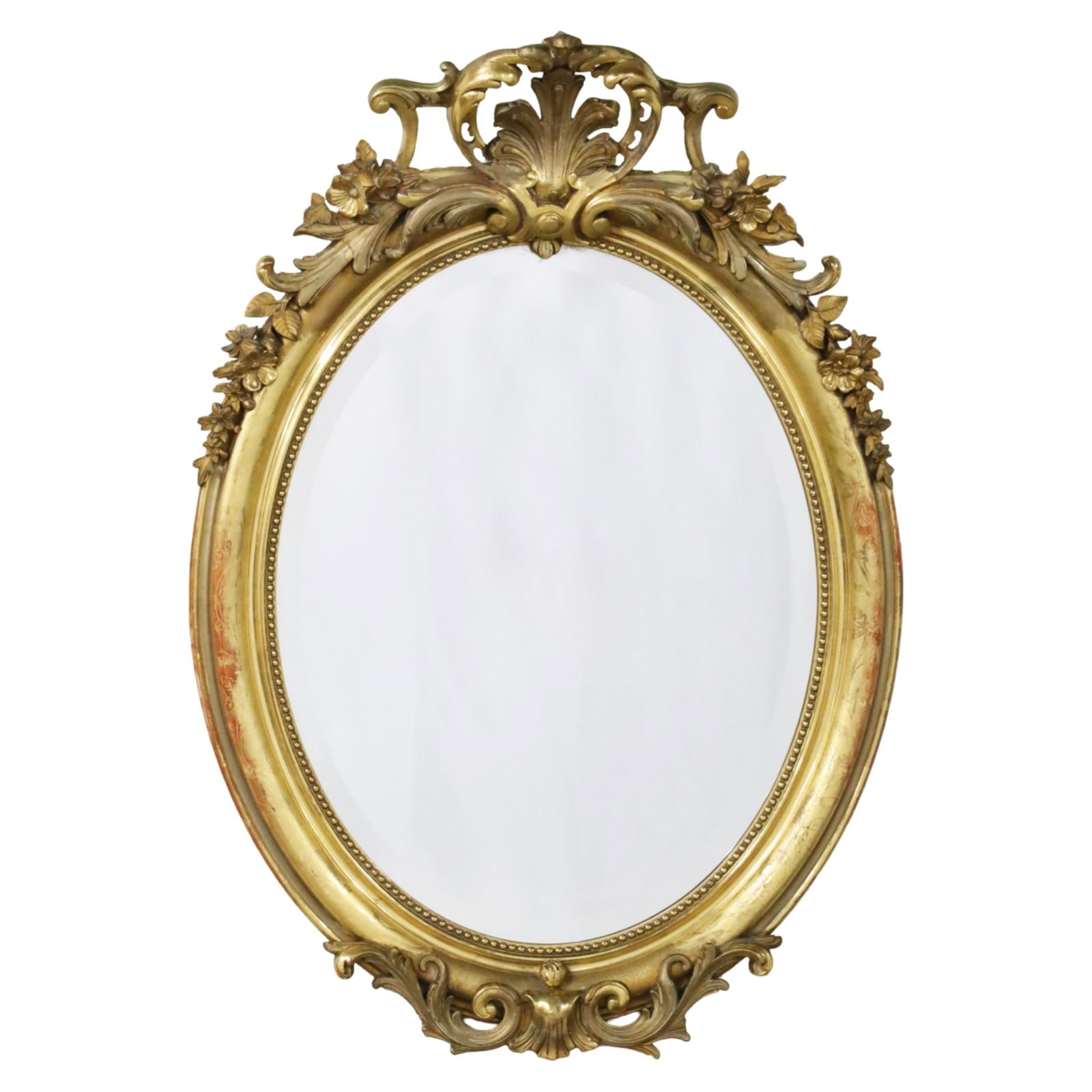 LOUIS XV STYLE GILTWOOD MIRROR, 19TH C.: Louis XV style oval giltwood bevel glass mirror, giltwood frame having intricate floral carvings and a shell crest, bead mold interior border, 19th century; 45"H 32"W 10"D