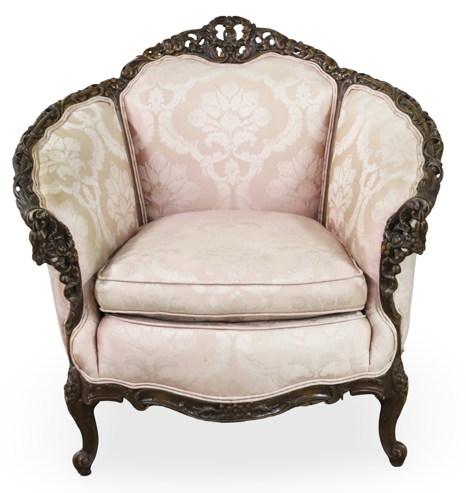 LOUIS XV STYLE BERGERE: Louis XV style bergere, possibly American, having elaborately carved crest rail and arms, covered in silk damask uphostery; 35"H 38"W 23"D