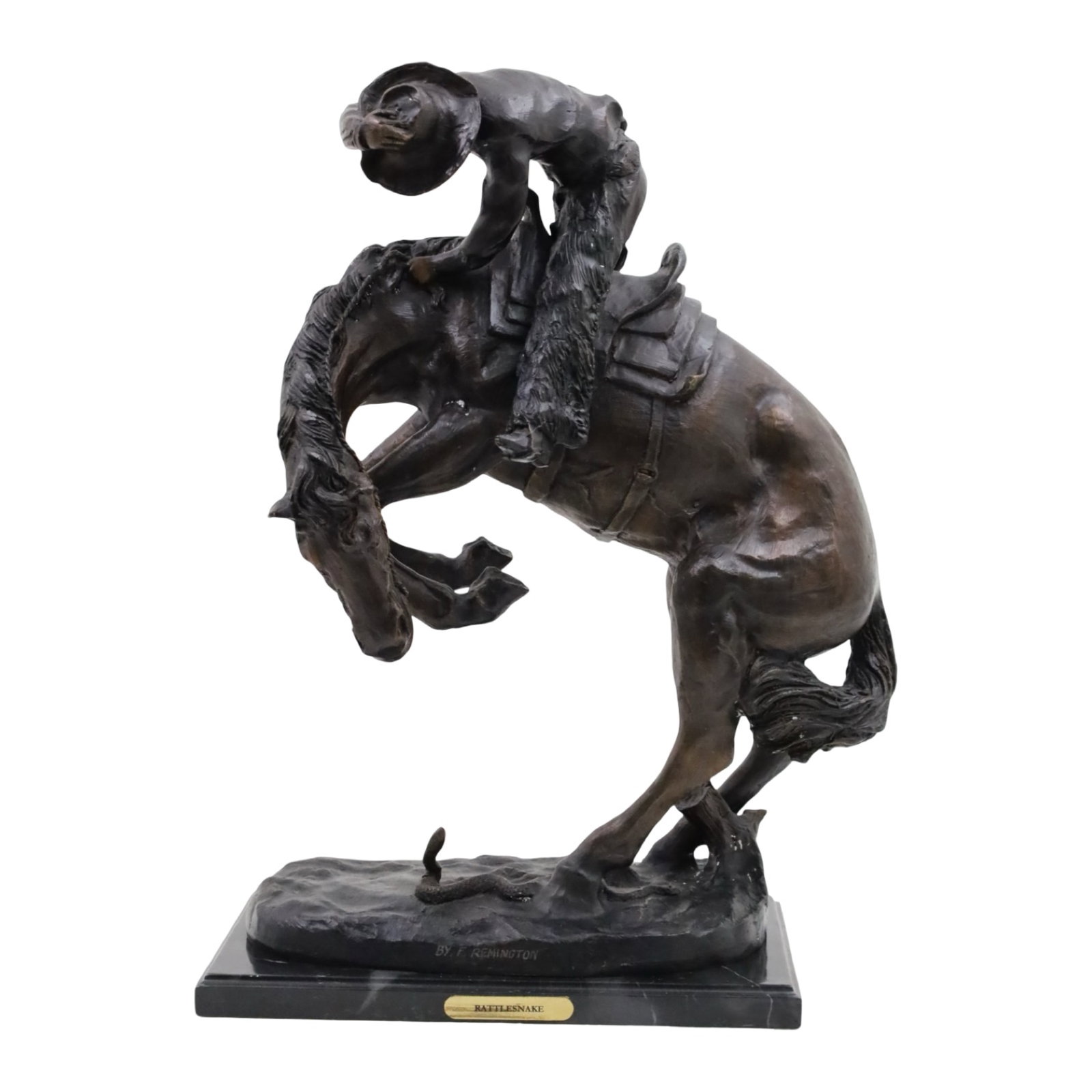 THE RATTLESNAKE, AFTER REMINGTON: Bronze sculpture of a cowboy clinging to the saddle as his horse bucks at the sight of rattlesnake beneath its feet, after the famous sculpture by Frederic Remington "The Rattlesnake" resting on
