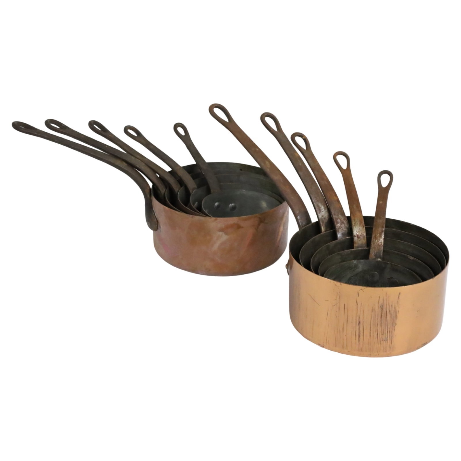 2 GRADUATING SETS OF COPPER PANS: 2 graduating sets of French copper pans with iron handles.