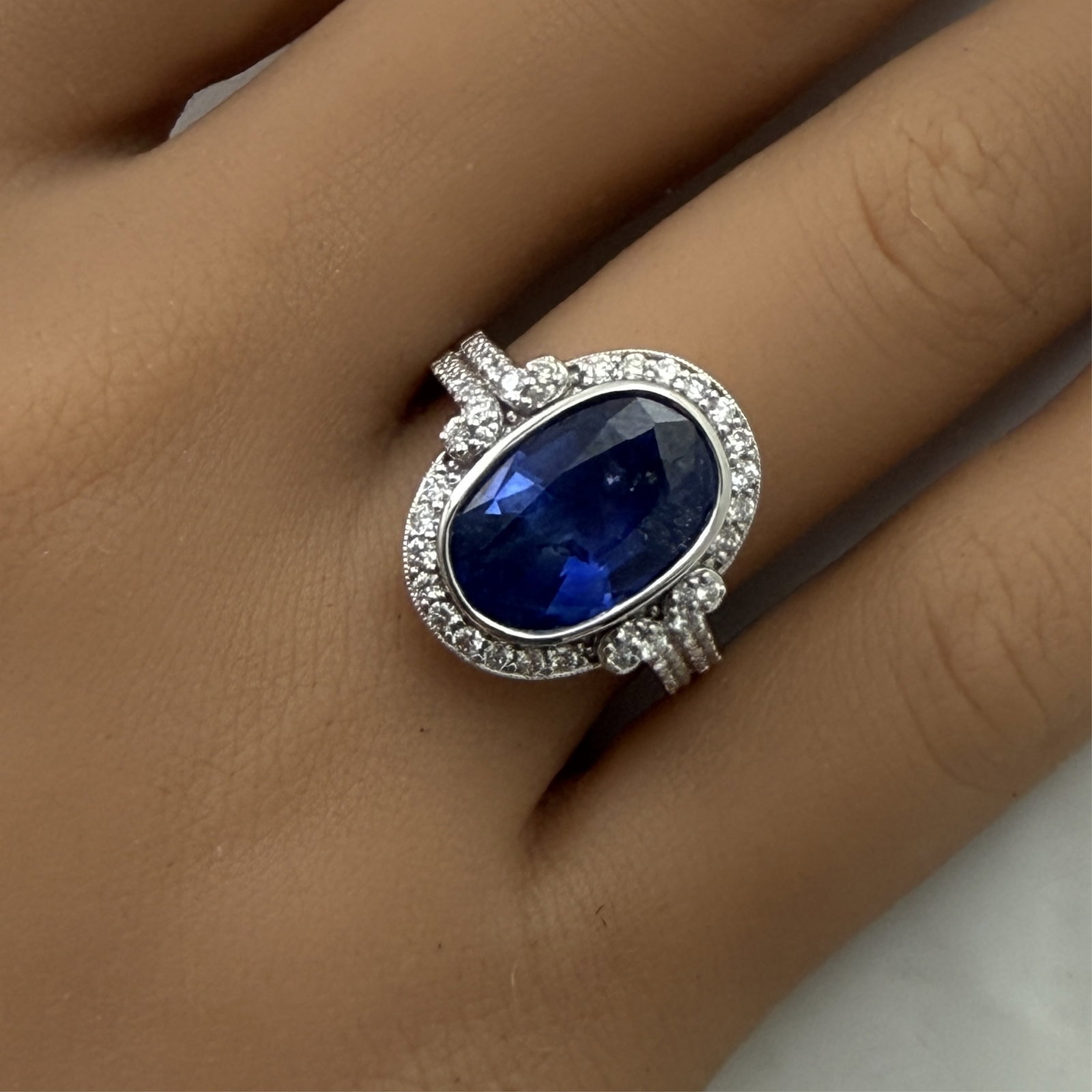PLATINUM SRI LANKA SAPPHIRE RING WITH GIA: Platinum ring with natural blue Sri Lanka GIA sapphire weighing 5.05ct surrounded by .60cts of VS1-VS2 diamonds. size 6.75 . total weight 10.1grams. Please see all photos, appraisal, and