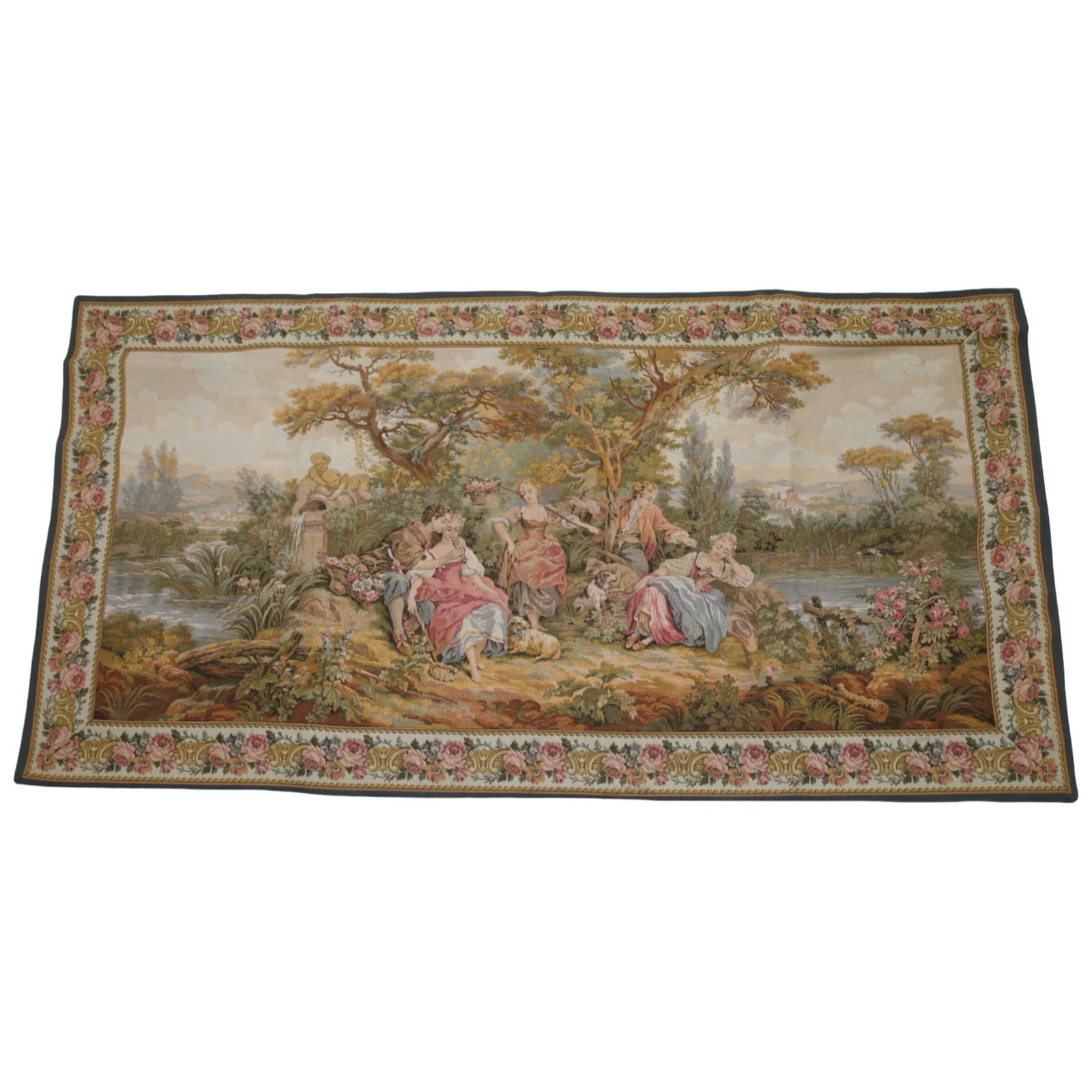 JP PARIS GOBELINS STYLE PASTORAL TAPESTRY: French machine-woven wall tapestry by JP Paris (Panneaux Gobelins) depicting an elegant Rococo pastoral scene with courting figures, musicians, dogs, and a garden fountain within a floral border. The 