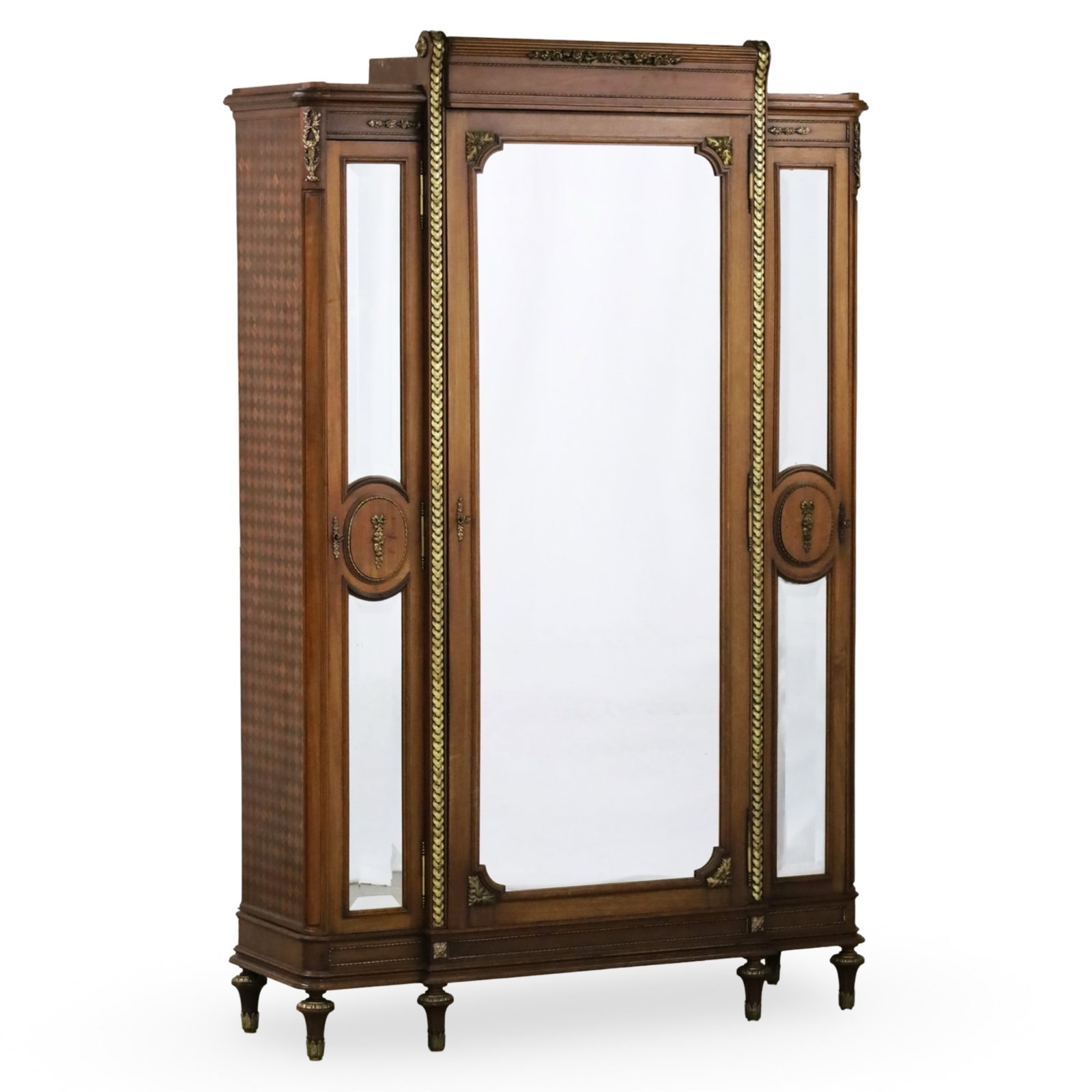 LOUIS XVI STYLE WALNUT MIRROR DOOR ARMOIRE: Louis XVI style walnut amoire, having three bevel mirror doors and parquetry side panels; 92"H 58"W 19"D