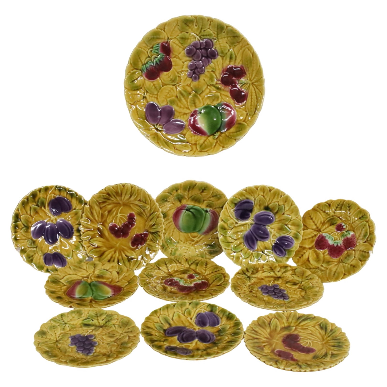 SARREGUEMINES FRENCH MAJOLICA DESSERT SERVICE: A fine French Majolica dessert service by Sarreguemines with 11 decorated high relief fruit plates and one 12" serving platter