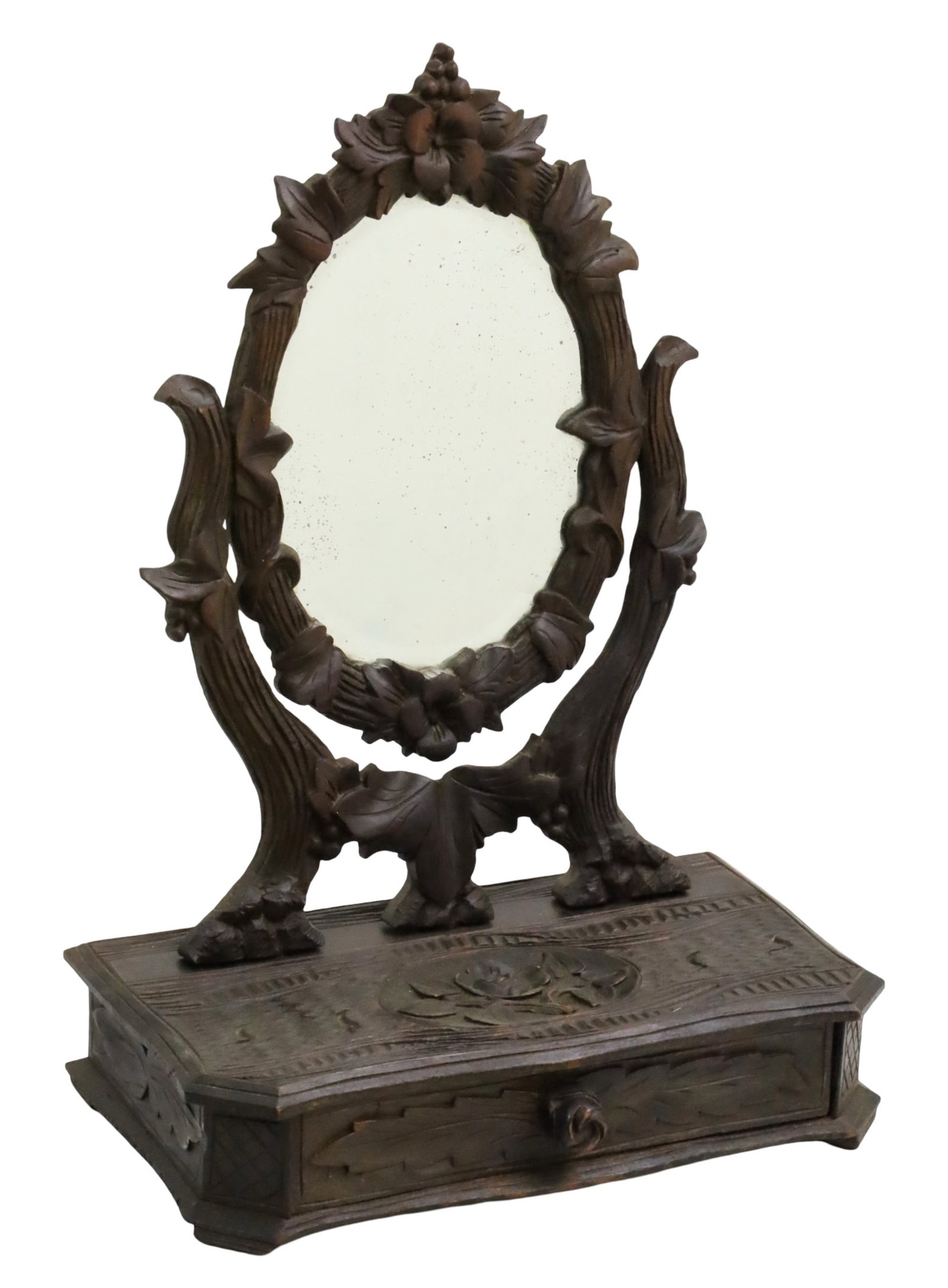 BLACK FOREST CARVED WALNUT VANITY MIRROR: Black Forest walnut dressing or vanity mirror, the frame decorated with carved floral motifs, resting on single drawer jewelry box; 17"H 12"W 7"D