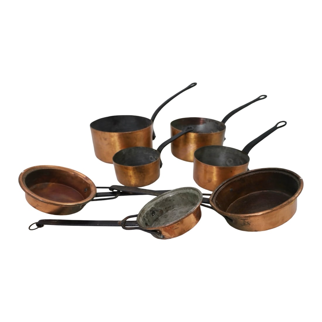 GROUP OF ANTIQUE COPPER COOKWARE: Group of antique graduated copper cookware including four saucepans with wrought iron handles and three long-handled warming or sauce pans.