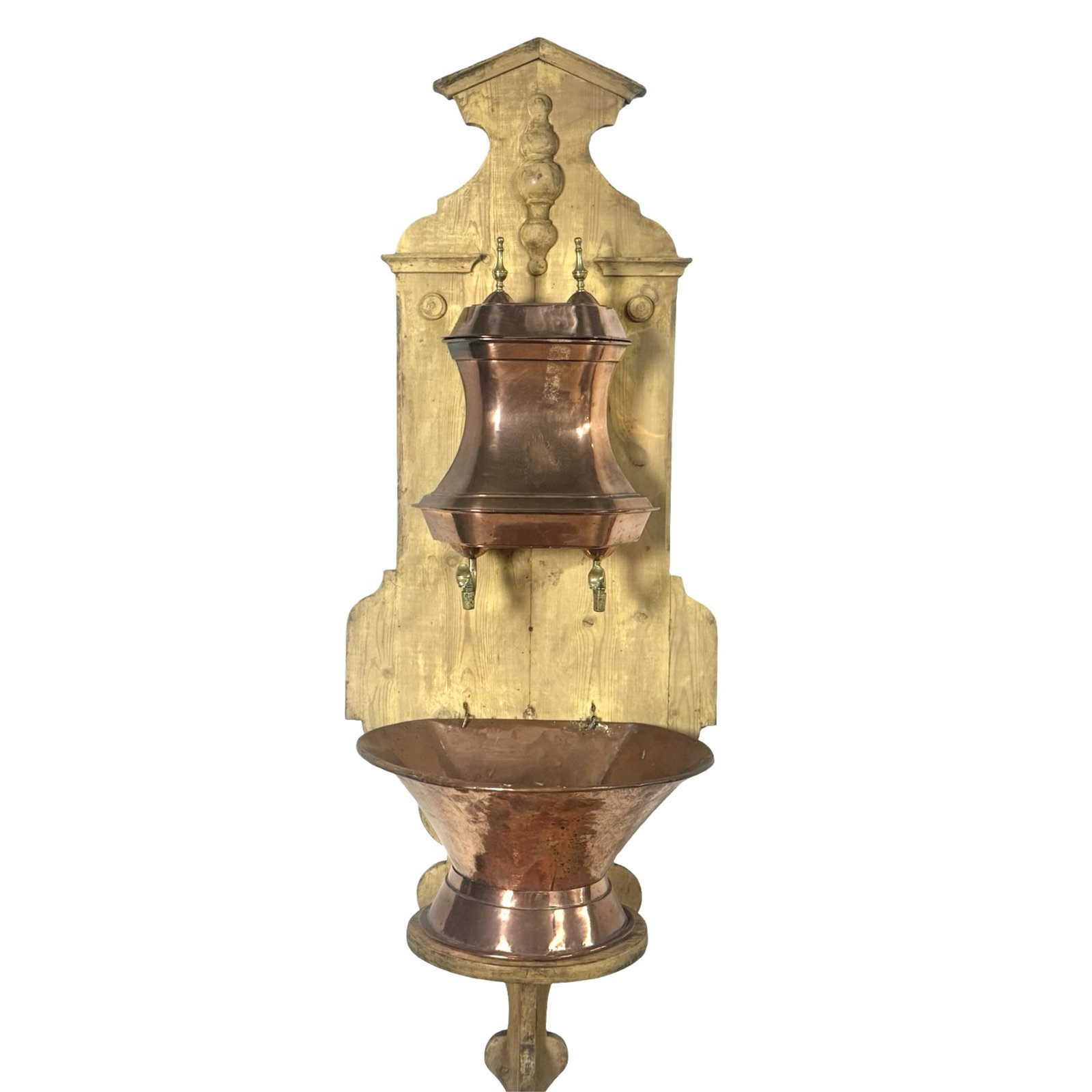 ANTIQUE COPPER LAVABO WALL FOUNTAIN: Antique copper wall-mounted lavabo fountain featuring a shaped wooden backboard, covered copper cistern with engraved decoration, twin brass spouts, and lower copper basin.24"W x 20"D x 72"H