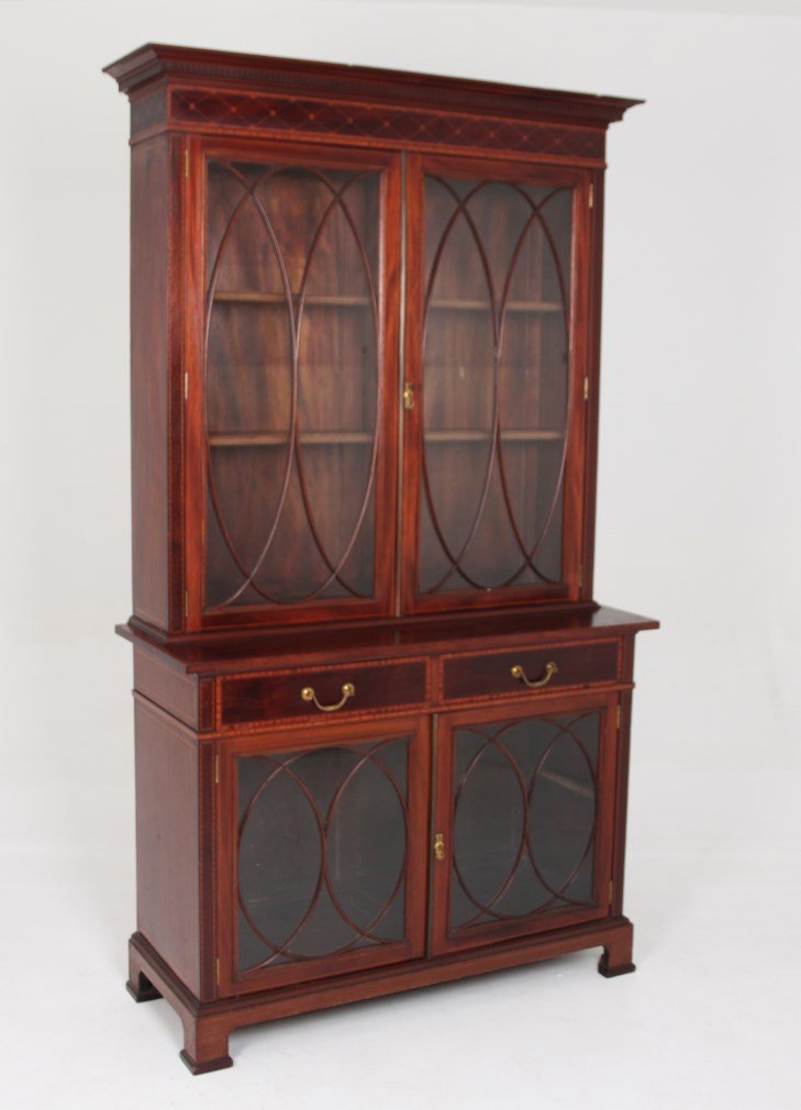 FINE QUALITY WARING & GILLOW ENGLISH INLAID BOOKCASE: FINE QUALITY WARING & GILLOW ENGLISH EDWARDIAN INLAID MAHOGANY TWO PART BOOKCASE WITH OVAL MULLION DOORS ON BRACKET FEET, LATE 19TH C.; 87"H X 49"W X 19"D