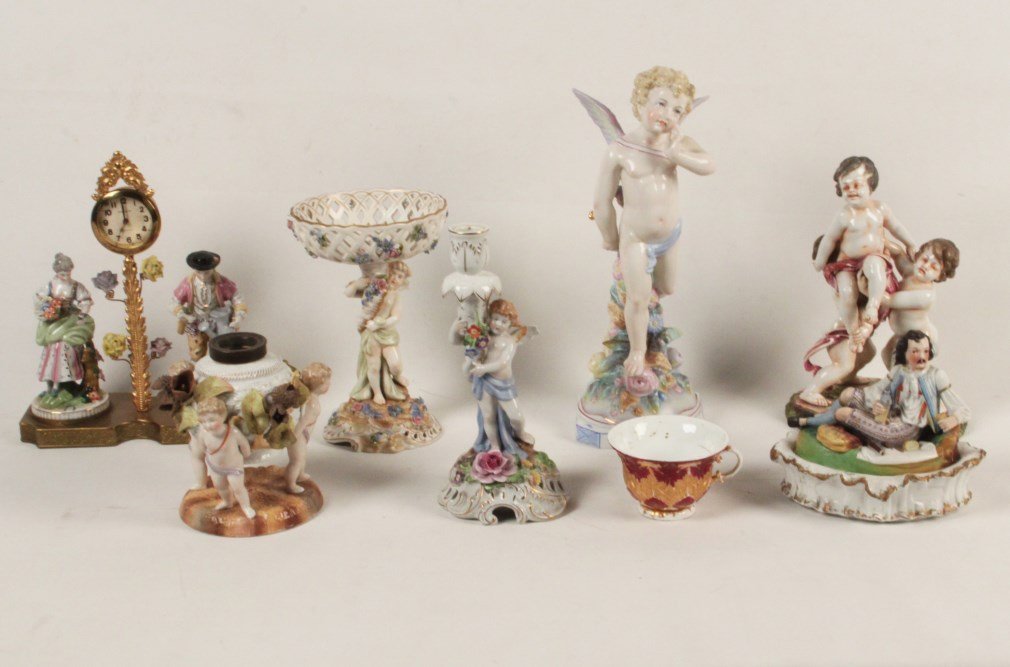 8 PIECE MISCELLANEOUS LOT OF CONTINENTAL PORCELAIN: 8 PIECE MISCELLANEOUS LOT OF CONTINENTAL PORCELAIN CONSISTING OF A FRENCH FIGURAL MOUNTED CLOCK, A CUPID FORMED FONT FOR LAMP, A TWO PART BOX WITH HUNTER RECLINED HAVING A PICNIC, A STANDING CUPID, A 