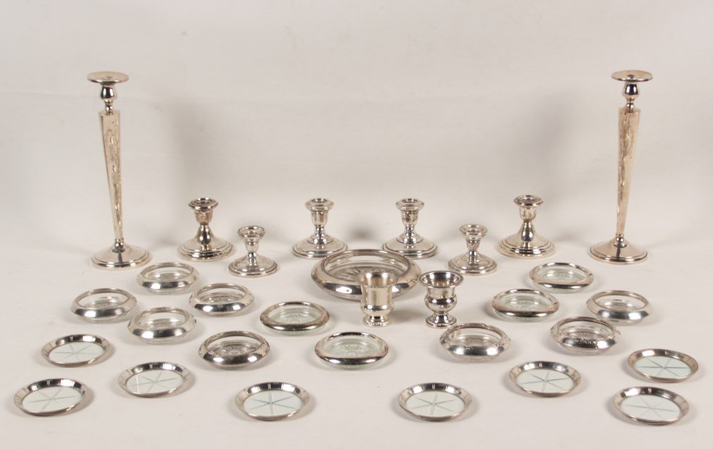 MISCELLANEOUS LOT OF 29 SILVER TABLE ITEMS: MISCELLANEOUS LOT OF 29 SILVER TABLE ITEMS CONSISTING OF A PAIR OF 12"H STERLING CANDLESTICKS (WEIGHTED), 20 COASTERS MOST WITH SILVER LIP, 6 SMALLER WEIGHTED STERLING CANDLESTICK HOLDER, 1 LARGE STER