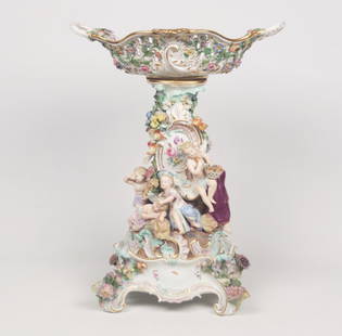 IMPRESSIVE 19TH C. MEISSEN FIGURAL MOUNTED PORCELAIN: IMPRESSIVE 19TH C. MEISSEN FIGURAL MOUNTED PORCELAIN COMPOTE ON CONFORMING FOOTED STAND HAVING PUTTI AND FLORAL DECORATION, BLUE CROSS SWORDS UNDER GLAZE ON THE REVERSE OF BOTH COMPOTE AND STAND; 