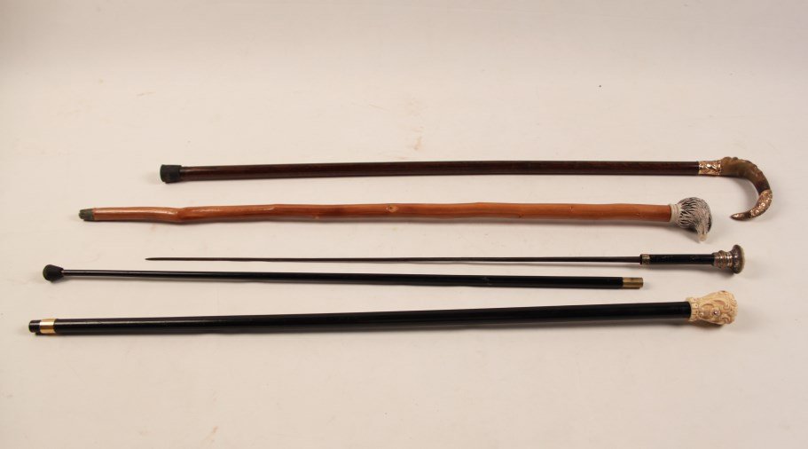 5 PIECE MISCELLANEOUS LOT: 5 PIECE MISCELLANEOUS LOT CONSISTING 2 CARVED IVORY HEAD CANES, ONE HAVING SWORD, 1 EAGLE HEAD CANE (CHIPS ON BEAK, MODERN), 1 GOLD AND HORN FORMED HANDLED PARASOL ; (NOT TESTED FOR PURITY), ALONG WIT