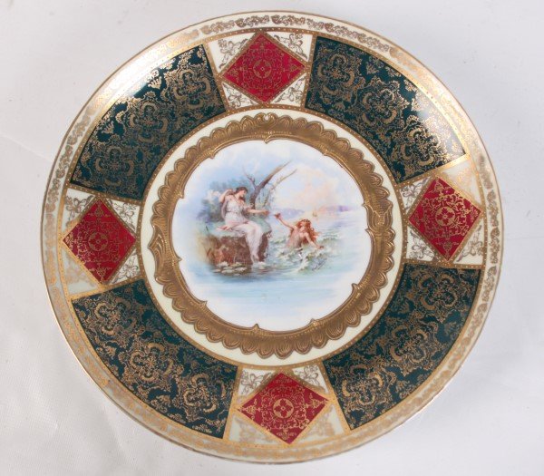 SIGNED ROYAL VIENNA CHARGER: SIGNED ROYAL VIENNA CHARGER HAVING GOLD EMBOSSED BORDER SURROUNDING CENTER VIGNETTE WITH WOMAN ON ROCK RECEIVING GIFT FROM MERMAID; 13.5"DIA