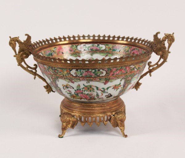BRONZE MOUNTED ROSE MEDALLION PORCELAIN COMPOTE: BRONZE MOUNTED ROSE MEDALLION PORCELAIN COMPOTE ON A STYLIZED ELEPHANT HEAD SUPPORTED BASE WITH WINGED BIRD HANDLES; 7"H X 14"W; CONDITION: GILDING ON BRONZE SHOWS AREAS OF WEAR CONSISTENT WITH AGE