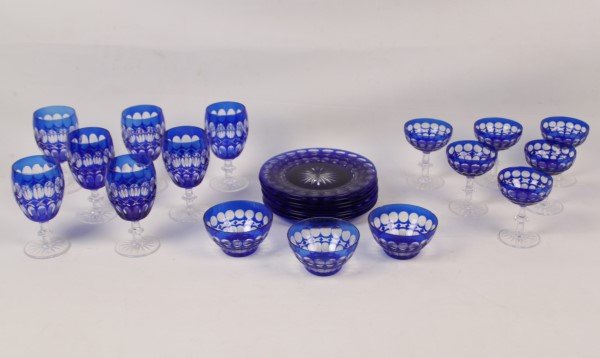 24 PIECES OF COBALT CUT TO CLEAR CRYSTAL: 24 PIECES OF COBALT CUT TO CLEAR CRYSTAL CONSISTING OF 7 GOBLETS, 6 CHAMPAGNES, 8 DESSERT PLATES, AND 3 FINGER BOWLS; CONDITION: 2 FINGER BOWLS WITH 2 RIM CHIPS EACH, 1 GOBLET WITH CHIPS TO BASE