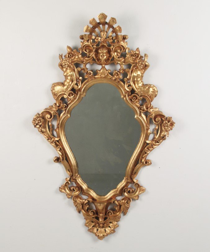 CONTINENTAL CARVED GILT WOOD MIRROR: CONTINENTAL CARVED GILT WOOD MIRROR HAVING PARTIALLY CLAD WOMEN SUPPORTS, 19TH C.; 47"H X 29"W