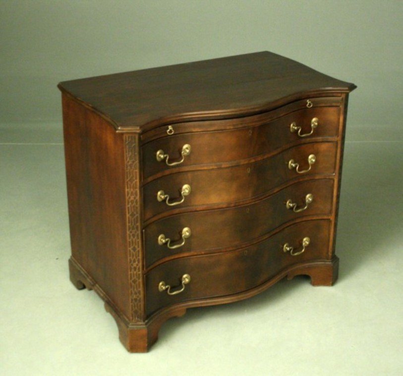 ENGLISH SERPENTINE MAHOGANY 4 DRAWER CHEST: ENGLISH SERPENTINE MAHOGANY 4 DRAWER CHEST HAVING BRUSHING SLIDE AND FRETWORK CHAMFERED CORNERS, MID 19TH C.; 31.5"H X 36"W X 22"D