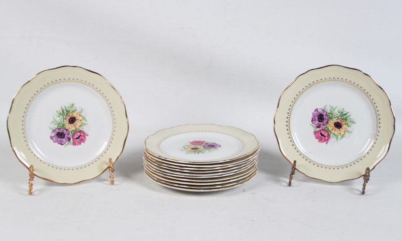 SET OF 12 FRENCH JAUNE AND GOLD RIMMED PLATES: SET OF 12 FRENCH JAUNE AND GOLD RIMMED 9.25" PLATES HAVING FLORAL CENTER RESERVES MARKED ON REVERSE L'AMANDIMORS COOPELIA"