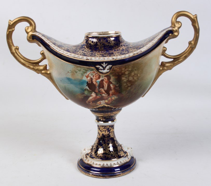 FRENCH SEVRES STYLE PORCELAIN URN: FRENCH SEVRES STYLE PORCELAIN URN HAVING CENTER RESERVE IN STYLE OF MURILLO, 1 QUARTER 20TH C.; 14"H X 17"W X 6"D