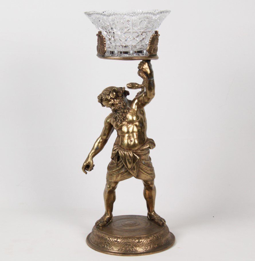GILT METAL FIGURE OF A GREEK GOD HOLDING CUT GLASS BOWL: GILT METAL FIGURE OF A GREEK GOD HOLDING CUT GLASS BOWL (ASSOCIATED); 25.5"H