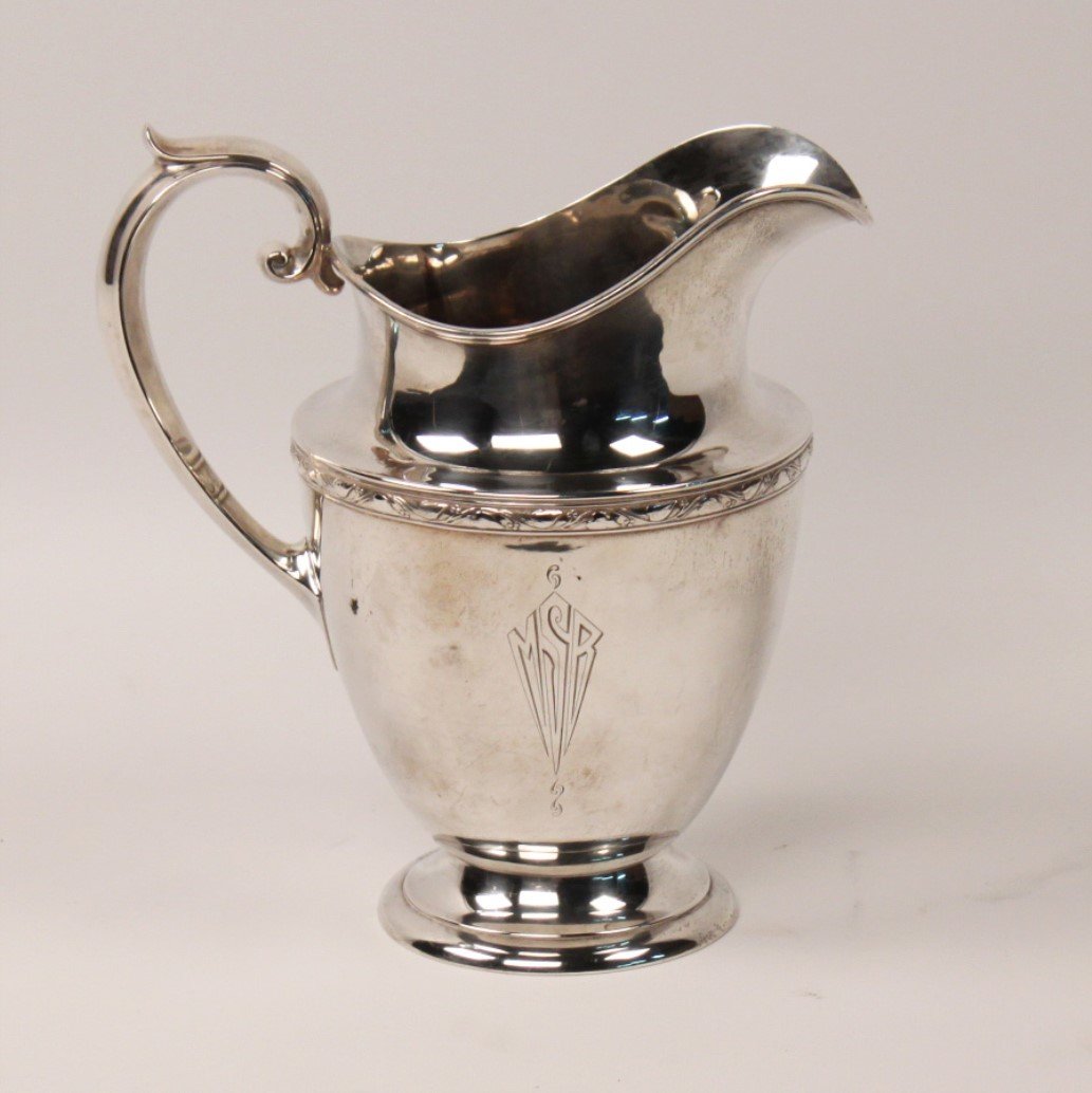 19 TROY OZS., STERLING SILVER PITCHER: STERLING SILVER PITCHER HAVING VINE EMBOSSED FRIEZE, 5 PINT, 19 TROY OZS WEIGHABLE, MONOGRAMED; 9.5"H; CONDITION: MINOR DINGS, SLIGHT DING TO RIM OF FOOT