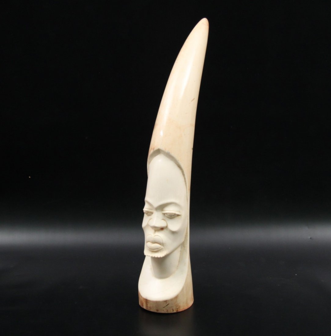 AFRICAN CARVED IVORY TUSK: AFRICAN CARVED IVORY TUSK HAVING BUST CARVING OF NATIVE TRIBESMAN; 18"; NOTE: There is no International shipping allowed on this lot, domestic USA sale only. Bidders should check for all applicable Go