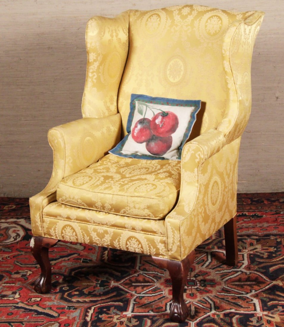 CHIPPENDALE STYLE CARVED MAHOGANY WING CHAIR: CHIPPENDALE STYLE CARVED MAHOGANY WING CHAIR OF GOOD PROPORTION COVERED IN ROYAL GOLD SILK TYPE FRENCH FABRIC, LATE 19TH/20TH C.; 43"H X 27"W X 21"D; CONDITION: SLIGHT WEAR TO WELTING OF ONE ARM, STRU