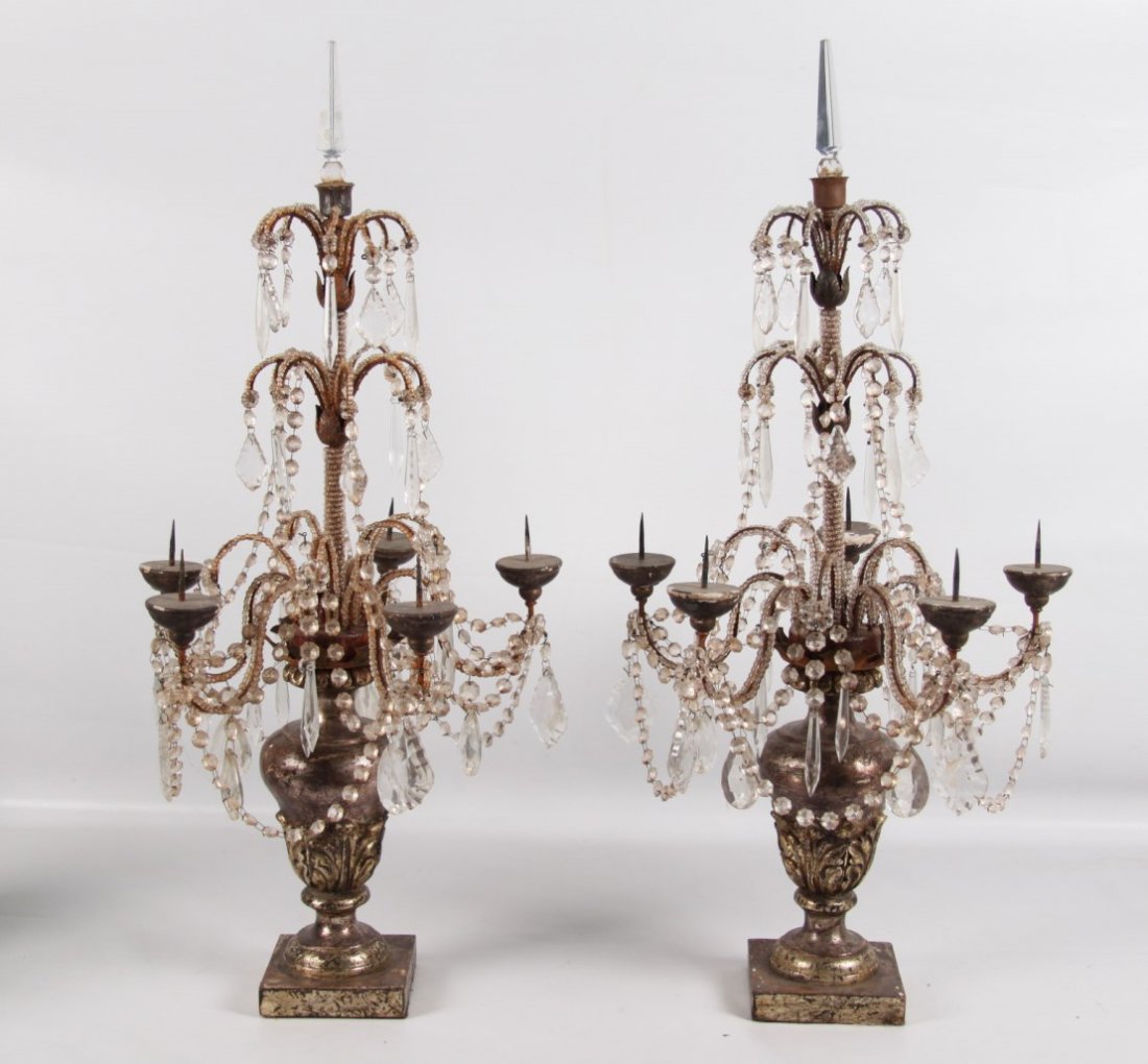 PAIR OF ITALIAN POLYCHROME CARVED AND CRYSTAL PRICKET: PAIR OF ITALIAN SILVER POLYCHROME CARVED WOOD AND CRYSTAL 6 BRANCH PRICKET CANDELABRA WITH ANCANTHUS CARVED URN RESTING ON SQUARE CONFORMING PLINTHS, 19TH C.; 33.5"H X 17"D