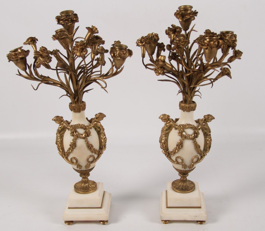 PAIR OF FRENCH BRONZE AND MARBLE CANDELABRA: PAIR OF FRENCH GILT AND DORE BRONZE 4 LIGHT WHITE MARBLE CANDELABRA HAVING MYTHOLOGICAL FEMALE PARTIALLY NUDE FIGURAL MOUNTS CONNECTED BY FLORAL WREATHS AND SWAGS ON STEPPED BLOCK PLINTH FOOTED BASES;