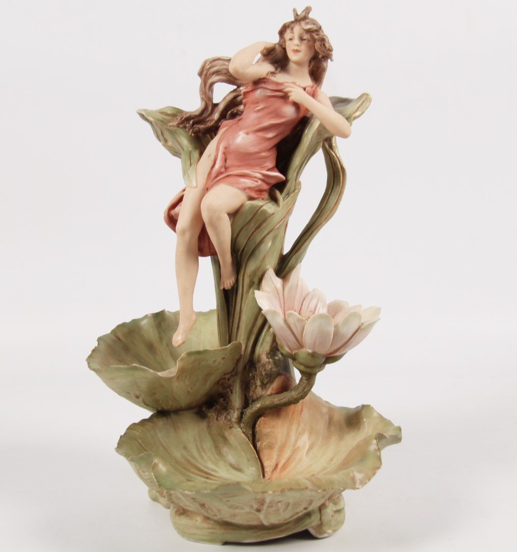 ROYAL DUX 4 TIER ART NOVEAU STYLE CENTERPIECE: ROYAL DUX 4 TIER ART NOVEAU STYLE CENTER PIECE HAVING A BEAUTIFUL SCANTILY DRESSED WOMAN RESTING ON A FLORAL AND SHELL FORMED RESERVE, MARKED ON REVERSE WITH PINK TRIANGLE ROYAL DUX BOHEMIA; 16"H X 10