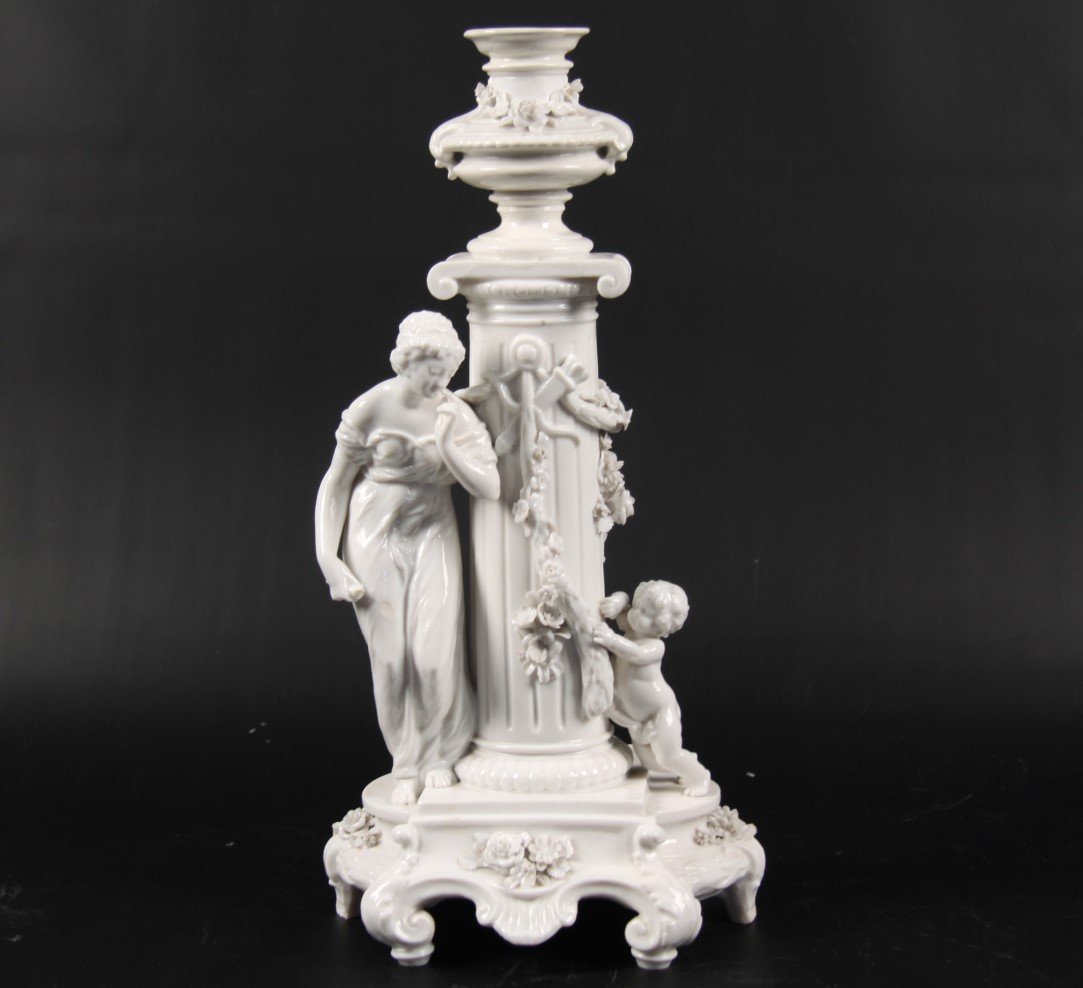 CONTINENTAL BLANC DE CHENE PORCELAIN MODEL: CONTINENTAL BLANC DE CHENE PORCELAIN MODEL COMPRISING OF A CLASSICAL WOMAN ATTENDED BY PUTTI HOLDING A VINE BESIDE IONIC COLUMN WITH URN SURMOUNT ON A SCROLL FORMED HEXAGON SHAPED PLINTH; 15"H; CONDIT