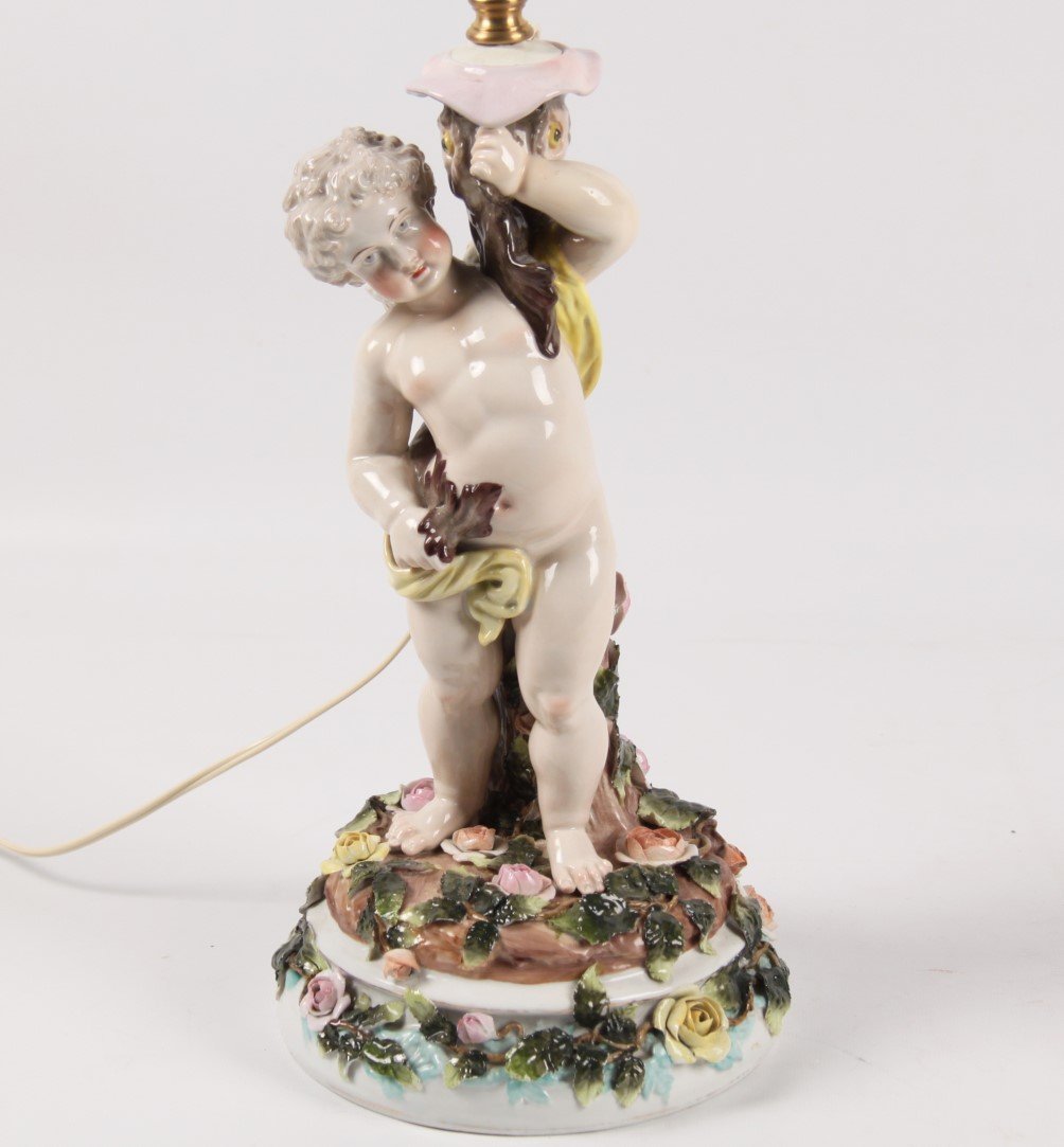 DRESDEN PORCELAIN FIGURE OF A CUPID: DRESDEN PORCELAIN FIGURE OF A CUPID HOLDING WHAT APPEARS TO BE A STURGEON, MARKED IN BLUE DOUBLE LINE CROSS WITH IMPRESSED "12" UNDERGLAZE; 15"H