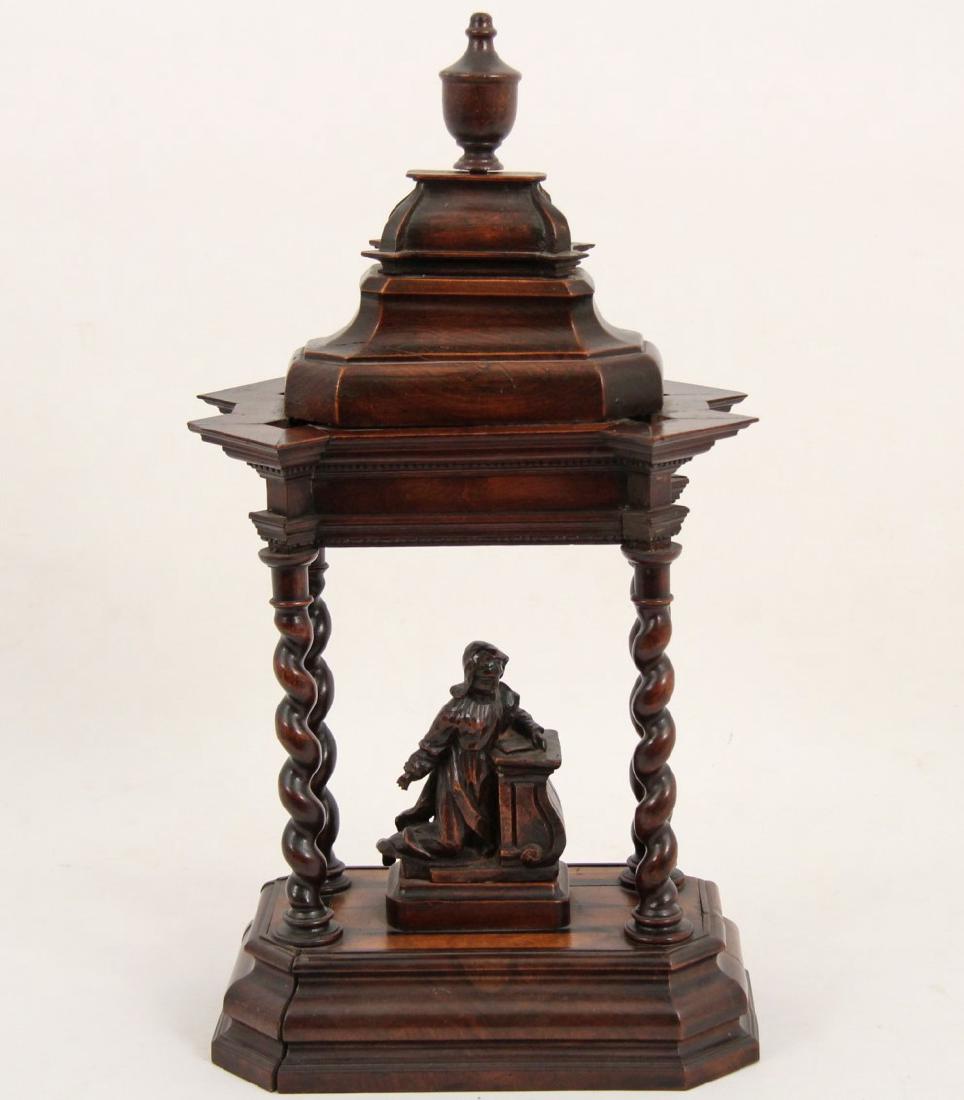EUROPEAN RELIGIOUS CARVED WALNUT ALTAR: EUROPEAN RELIGIOUS CARVED WALNUT ALTAR HAVING KNEELING FIGURE, 19TH C.; 21"H X 11"W X 8"D; CONDITION: SOME CHIPS TO HAND ON FIGURE, A PIECE OF MOULDING OFF ON CORONET, AGE SEPARATION ON FACE MOULDING