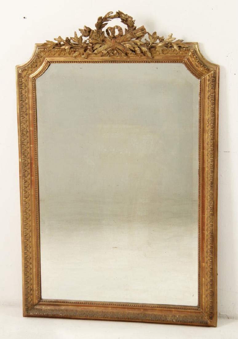 19TH C. FRENCH CARVED GILTWOOD MIRROR: FRENCH CARVED GILTWOOD AND GESSO MIRROR HAVING OPEN WREATH WITH QUIVER FOLIATED TOP AND BEVEL GLASS, FRANCE 19TH C.; 59.5"H X 38.5"W