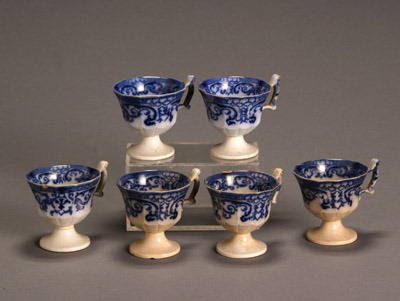 Set of Six Flow Blue Punch Cups: Set of Six Flow Blue Punch Cups Each with minor chips; three with slight discoloration. Height: 3-1/4 in